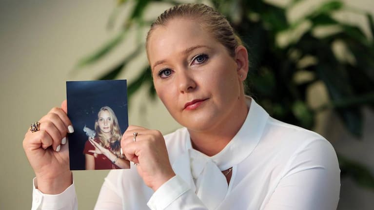 Virginia Giuffre, with a photo of herself as a teen, when she says she was abused by Jeffrey Epstein, Ghislaine Maxwell and Prince Andrew, among others.