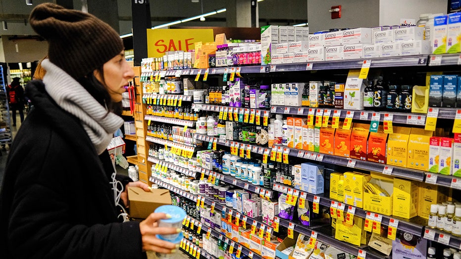 A shopper looks at vitamins and supplements