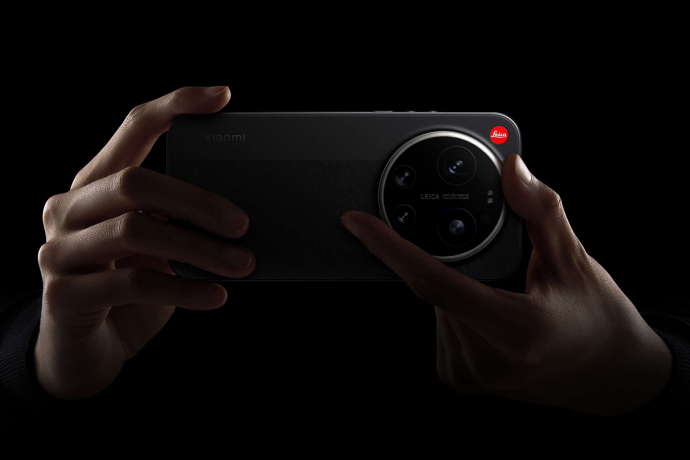 Xiaomi 17 Ultra Leica Edition with a hand ready to twist the manual camera zoom