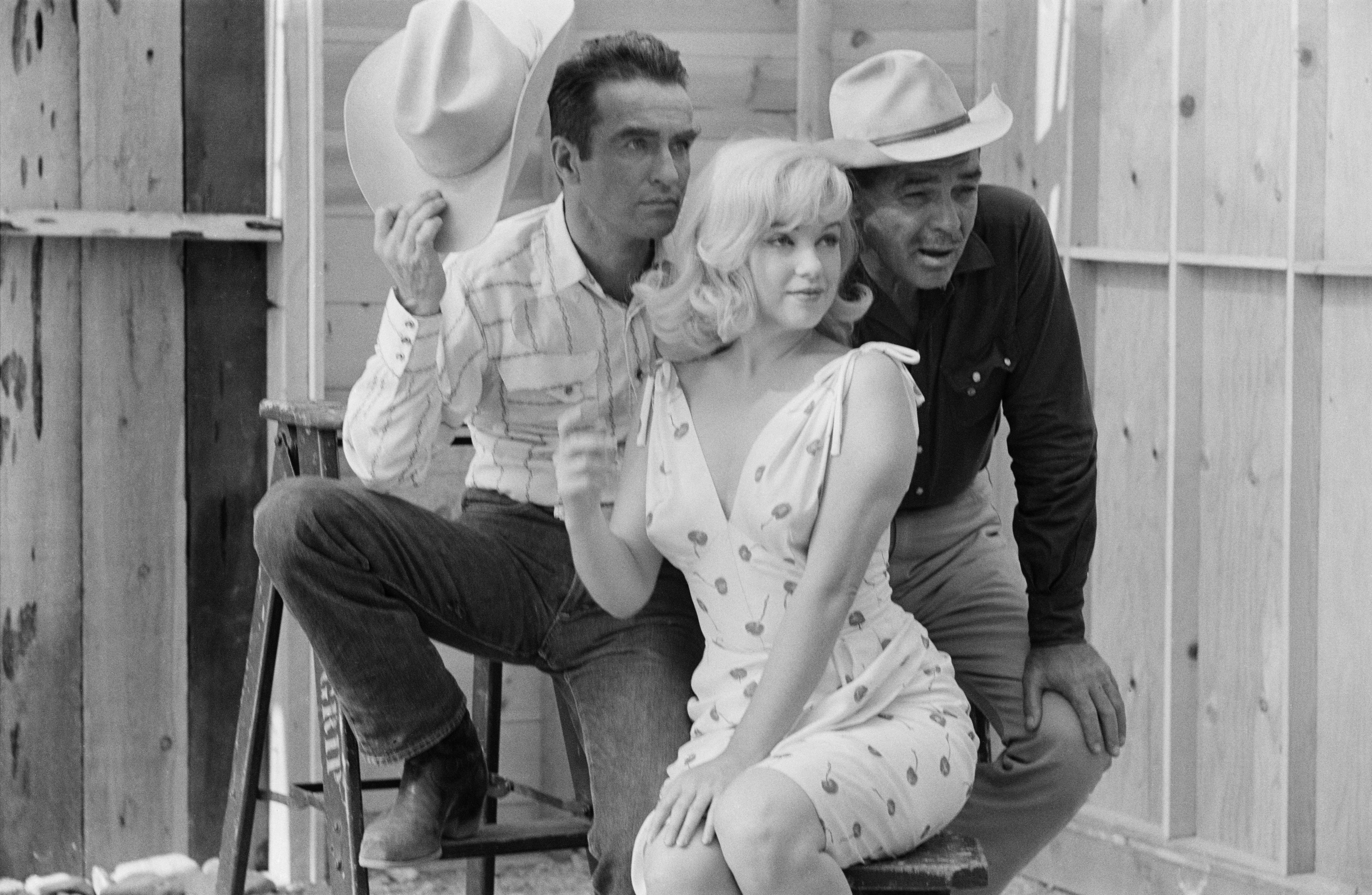 American actors Montgomery Clift, Marilyn Monroe, and Clark Gable pose for a publicity shoot for the film 'The Misfits'.