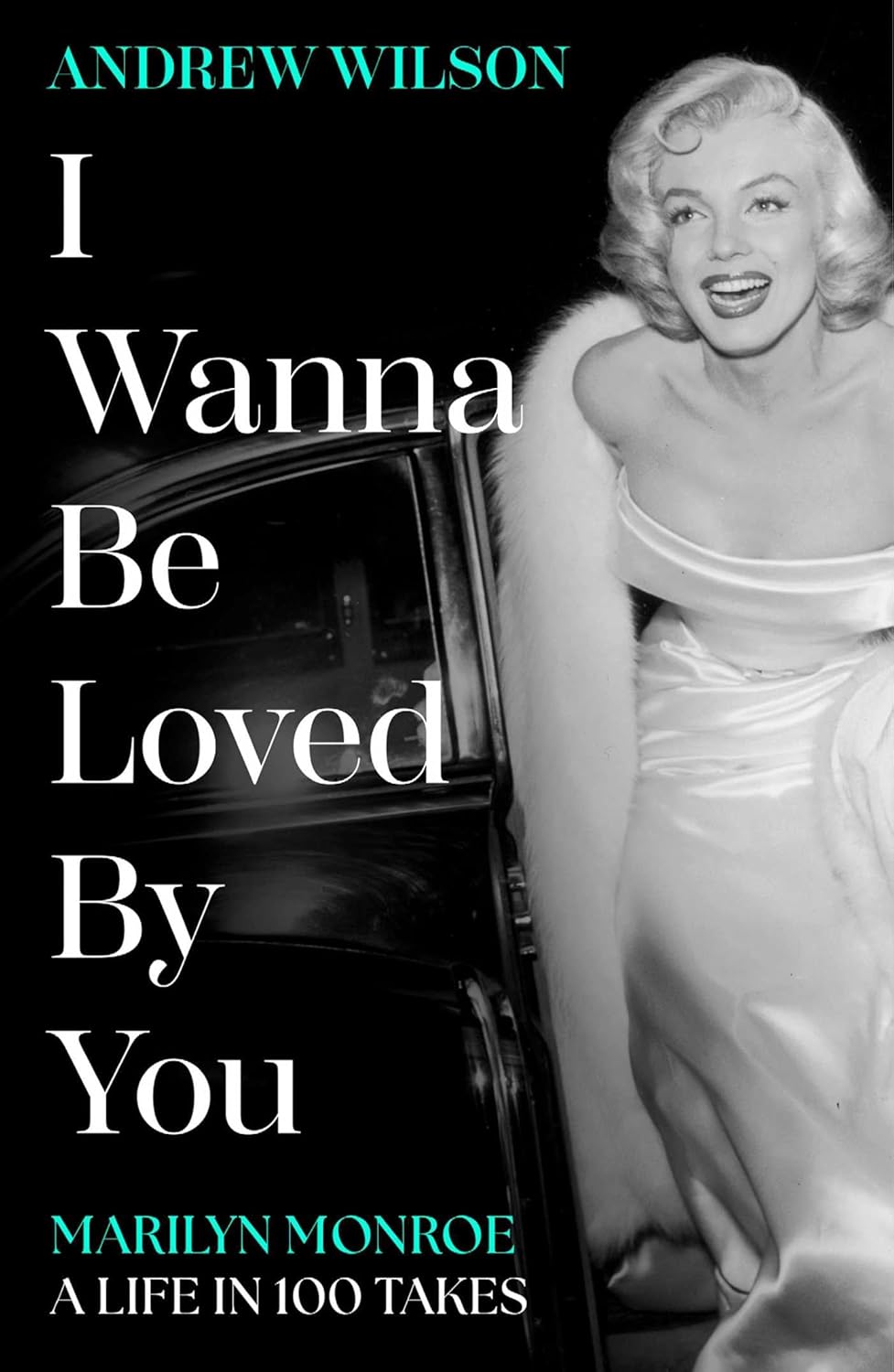 Book cover for "I Wanna Be Loved By You" featuring a black and white photo of Marilyn Monroe in a strapless gown and fur stole.
