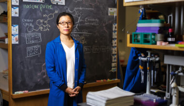 Christina Woo standing in front of a chalkboard.