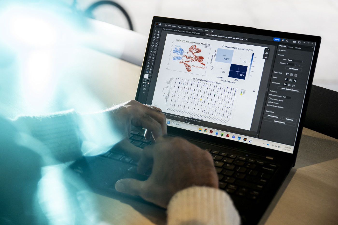A pair of hands at a laptop that displays a multifunctional user interface.
