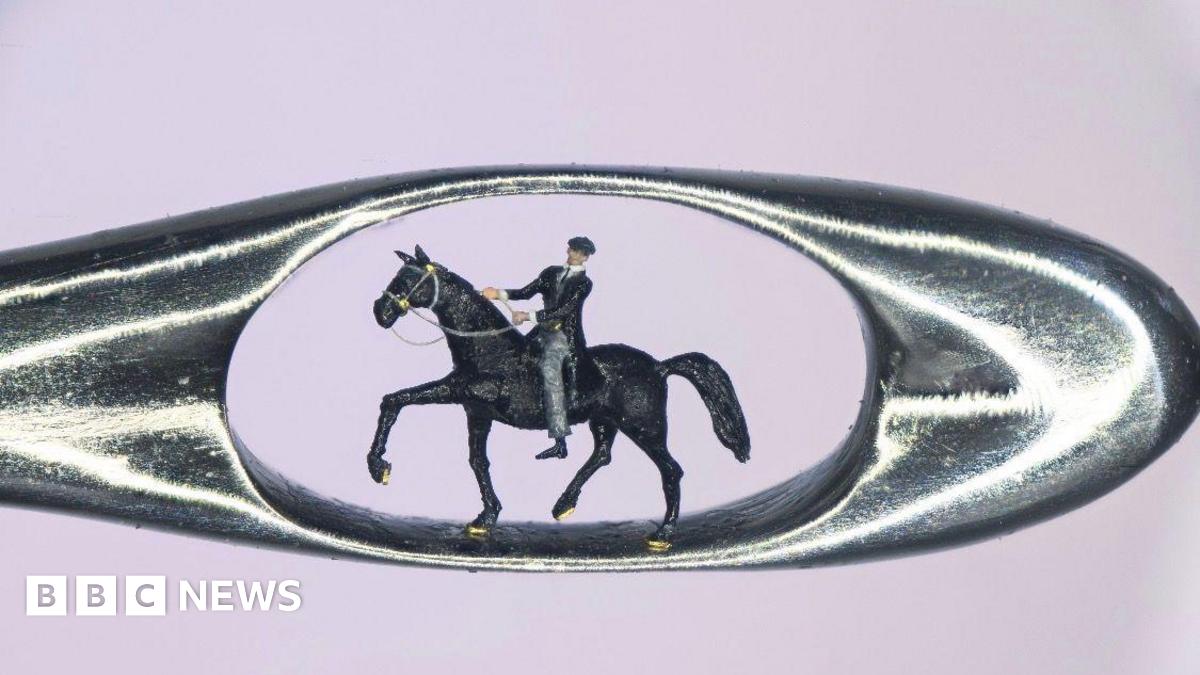 A zoomed-in picture of a micro model of Tommy Shelby riding a horse inside a needle's eye