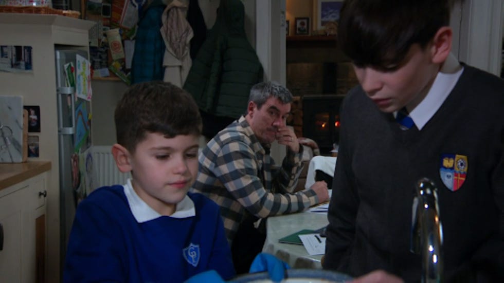 children and an adult in a home kitchen setting