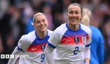 A smiling Lucy Bronze celebrates opening the scoring for England