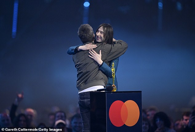 The singer was introduced by Primal Scream frontman Bobby Gillespie, who awarded him the prize (seen together on stage)