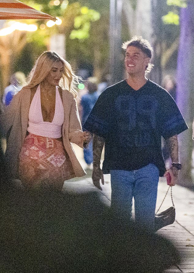 Alan, also 35, opted for a more casual look, wearing a black Kusbi T-shirt, slim blue jeans and white sneakers, showing off his tattooed arms as he walked beside Gia