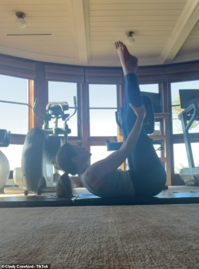 At 8AM Cindy headed to her private and lavish gym and displayed her impressive flexibility as she began her workout by stretching on the mat