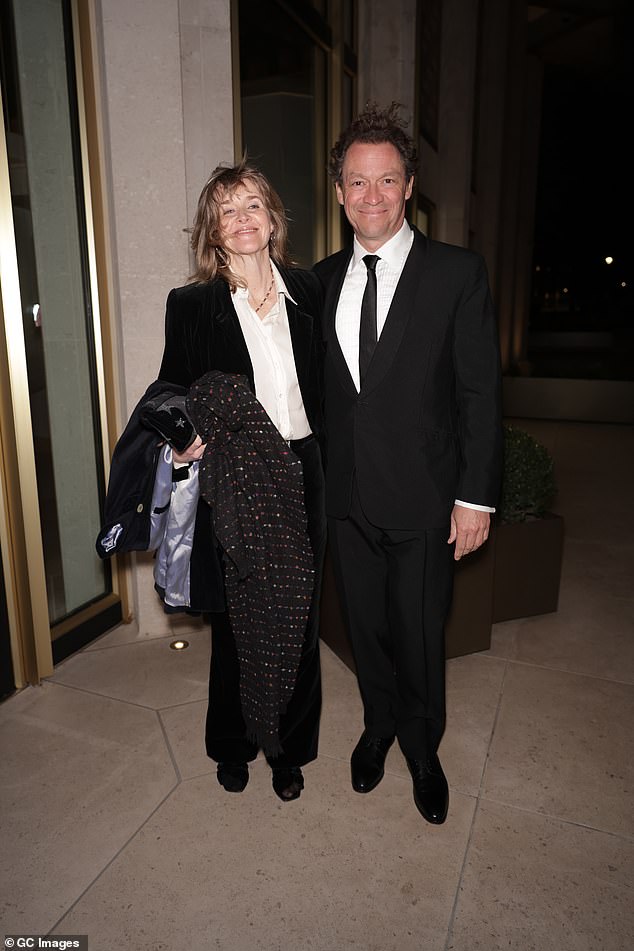 The pair put on a united display as they posed for a photo inside the venue after braving the fierce wind to get to the bash
