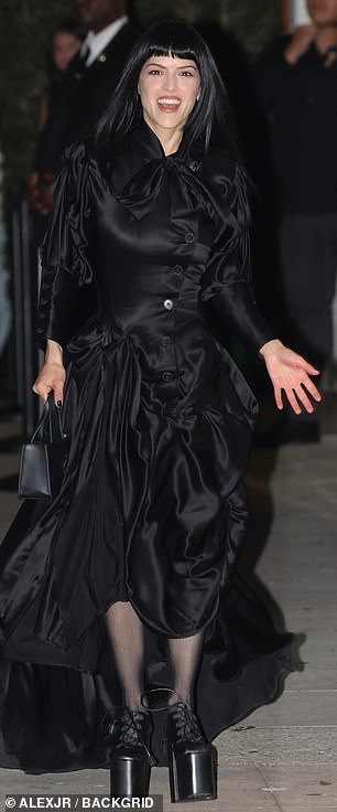 Puerto Rican singer Maria Zardoya opted for a Gothic black look including a ruched skirt with a train, a top with an extravagant collar and towering platform heels