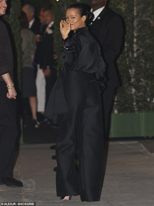 Russell - who is now slated to star with Jenna Ortega in a Single White Female remake - rocked a set of black slacks with a bow, plus a matching blouse