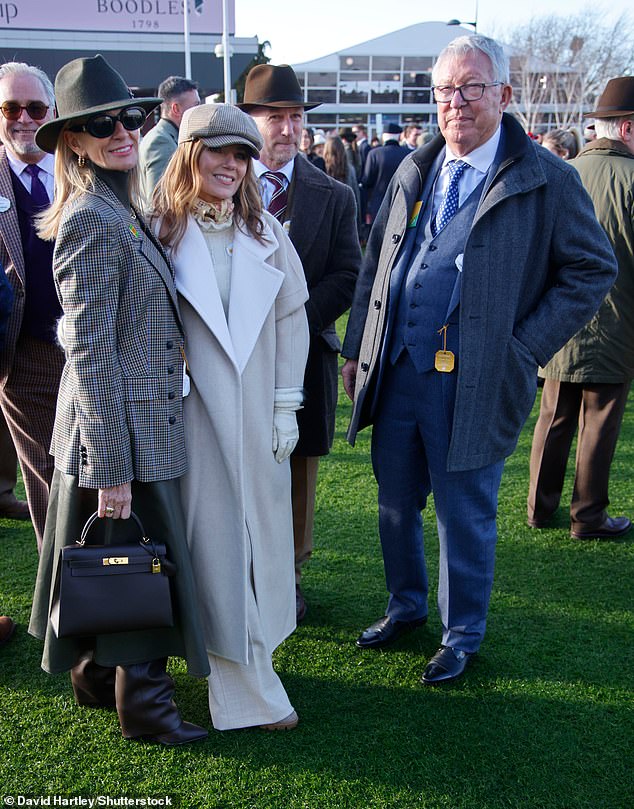 Geri Halliwell was seen posing for snaps in another all-white ensemble consisting of a long coat and linen trousers alongside Sir Alex Ferguson