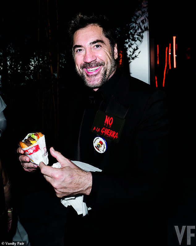 Actor Javier Bardem posing with an In-N-Out burger at the event