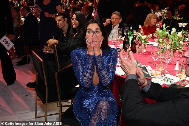 The star put on a dazzling display in a plunging blue sequinned gown as she arrived for the event with her fiancé Callum Turner