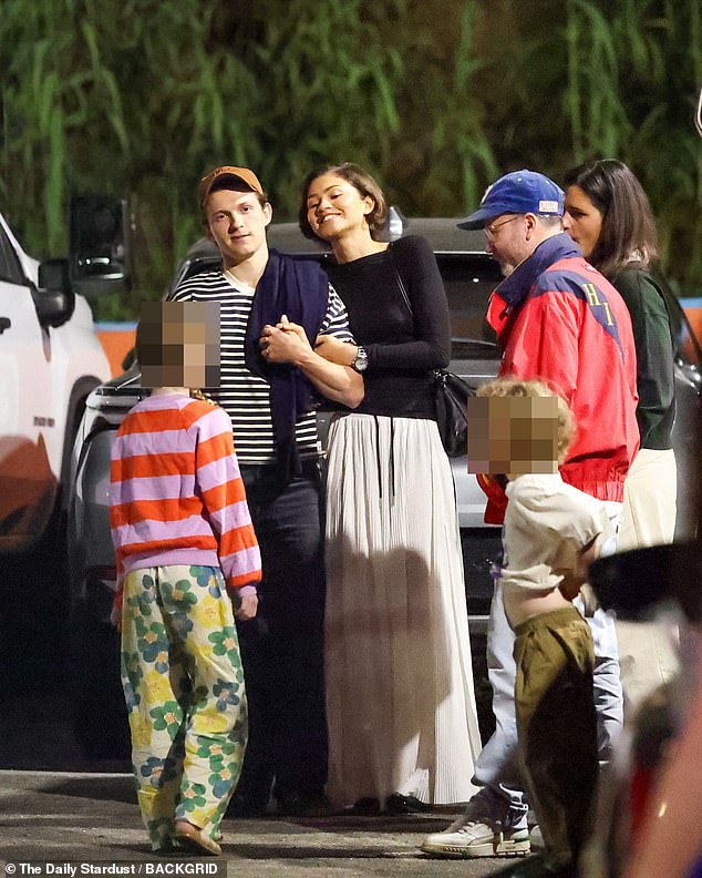 The pair seemed to be amused by something as they conversed with the children