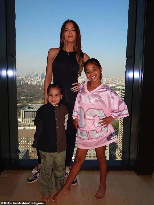 The 41-year-old reality star proudly posed with her three-year-old son Tatum Thompson and seven-year-old daughter True Thompson in front of the window of a high-rise building, presumably their hotel
