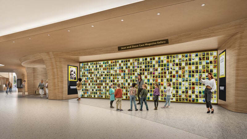 A group of people, including children, view a large gallery wall filled with many colorful magazine covers in a spacious, modern hallway labeled "Joan and Steve Case Magazine Gallery.