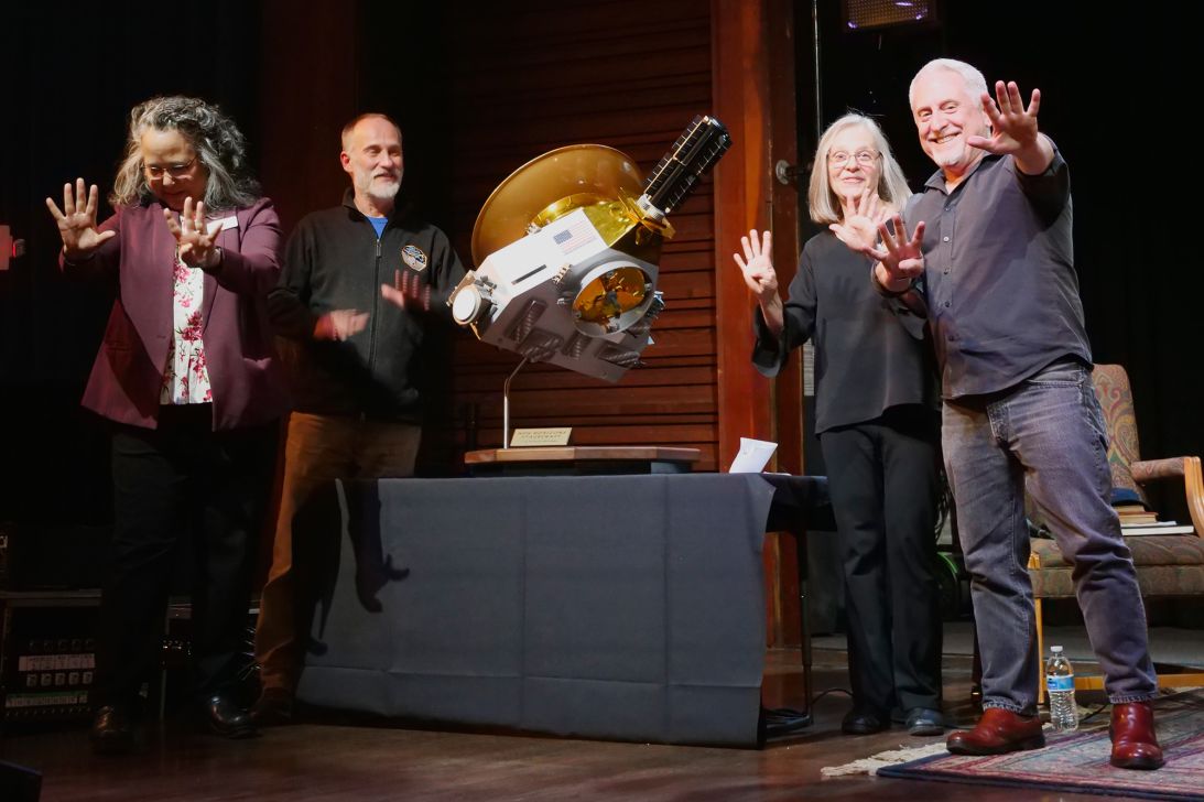 From left: Amanda Bosh and Will Grundy of the Lowell Observatory, and Alice Bowman and Alan Stern of NASA's New Horizons mission, hold up nine fingers as a salute to Pluto, known as the ninth planet for decades. The scale model between them is of the New Horizons spacecraft, which flew by Pluto in 2015.