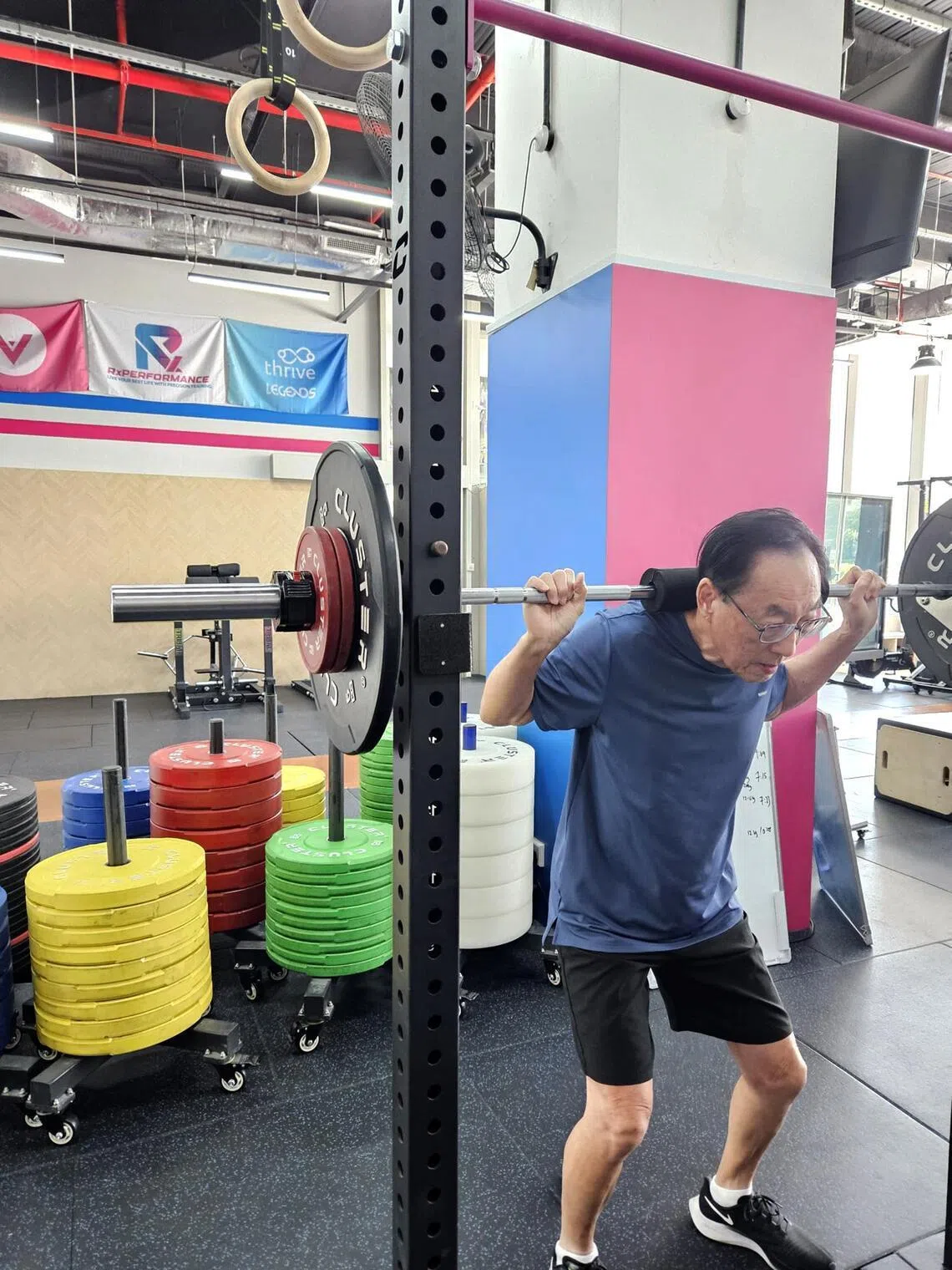 Mr Steven Tan, 74, doing a back squat at Rx Performance at Outram.