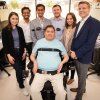 Keith Thomas, who lives with paralysis, poses with the research team at Northwell Health’s Feinstein Institutes for Medical Research that worked with him for months to restore lasting movement and feeling in his arm and hand. The first-of-its-kind ‘double neural bypass’ system uses brain implants and artificial intelligence to allow signals to and from Thomas’ brain to bypass the site of his injury.