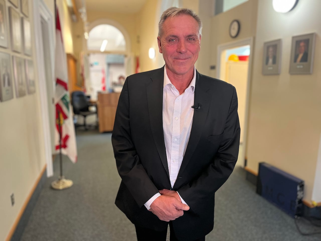 A man in a black suit.