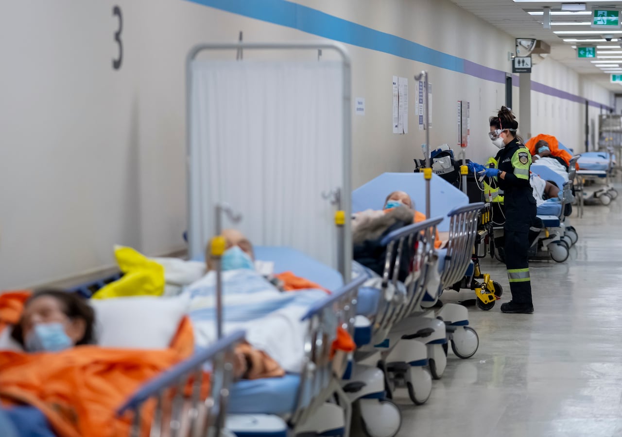 An empty hospital bed in a hallway