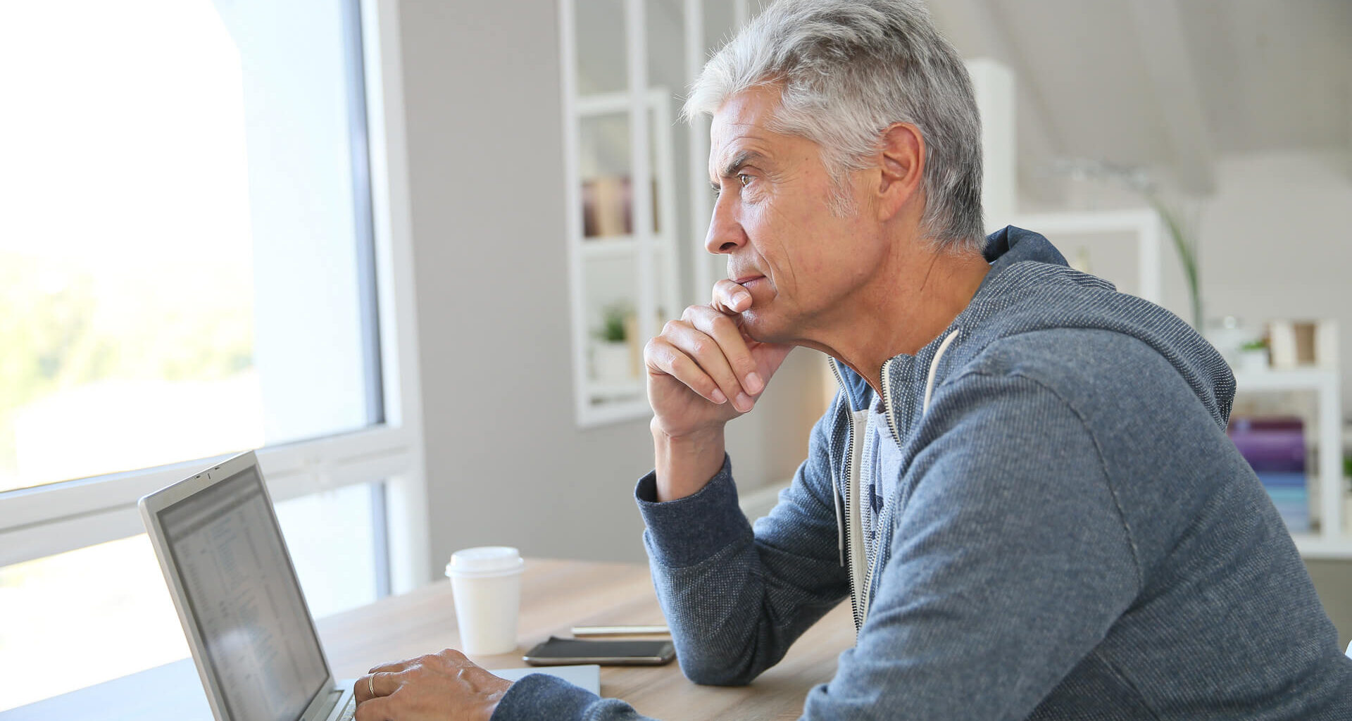 Senior thinking about his finances, investments, retirement plans and other money considerations.