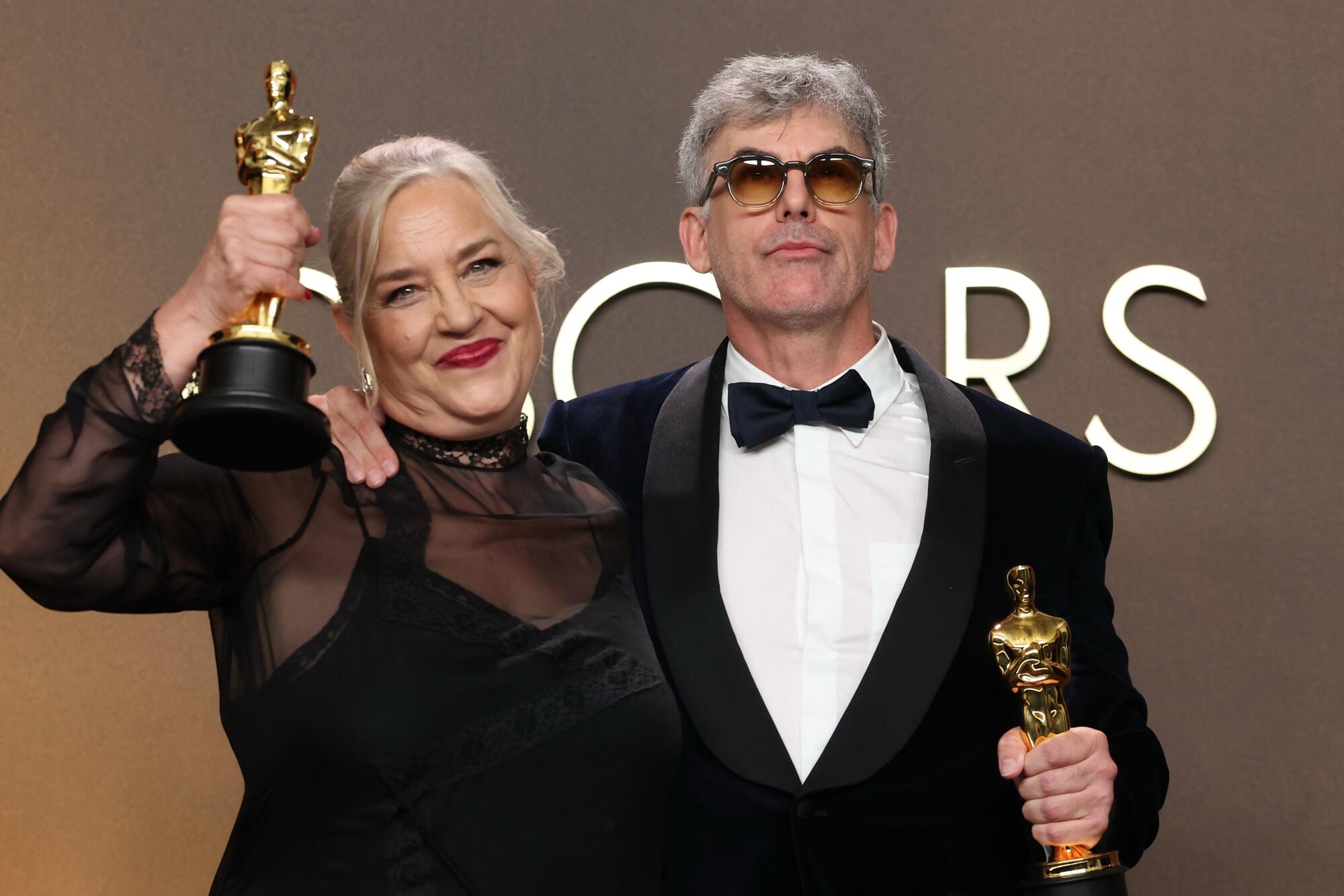 Tamara Deverell, left and Shane Vieau hold oscars in the press room