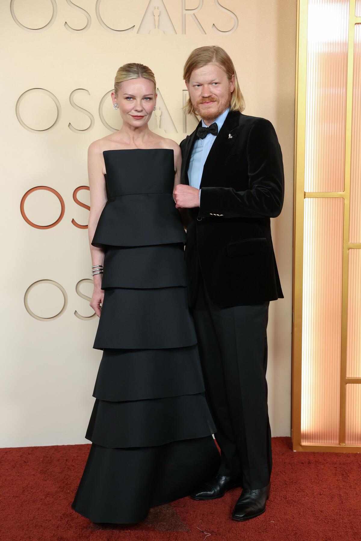 Kirsten Dunst and Jesse Plemons pose on the Oscars red carpet