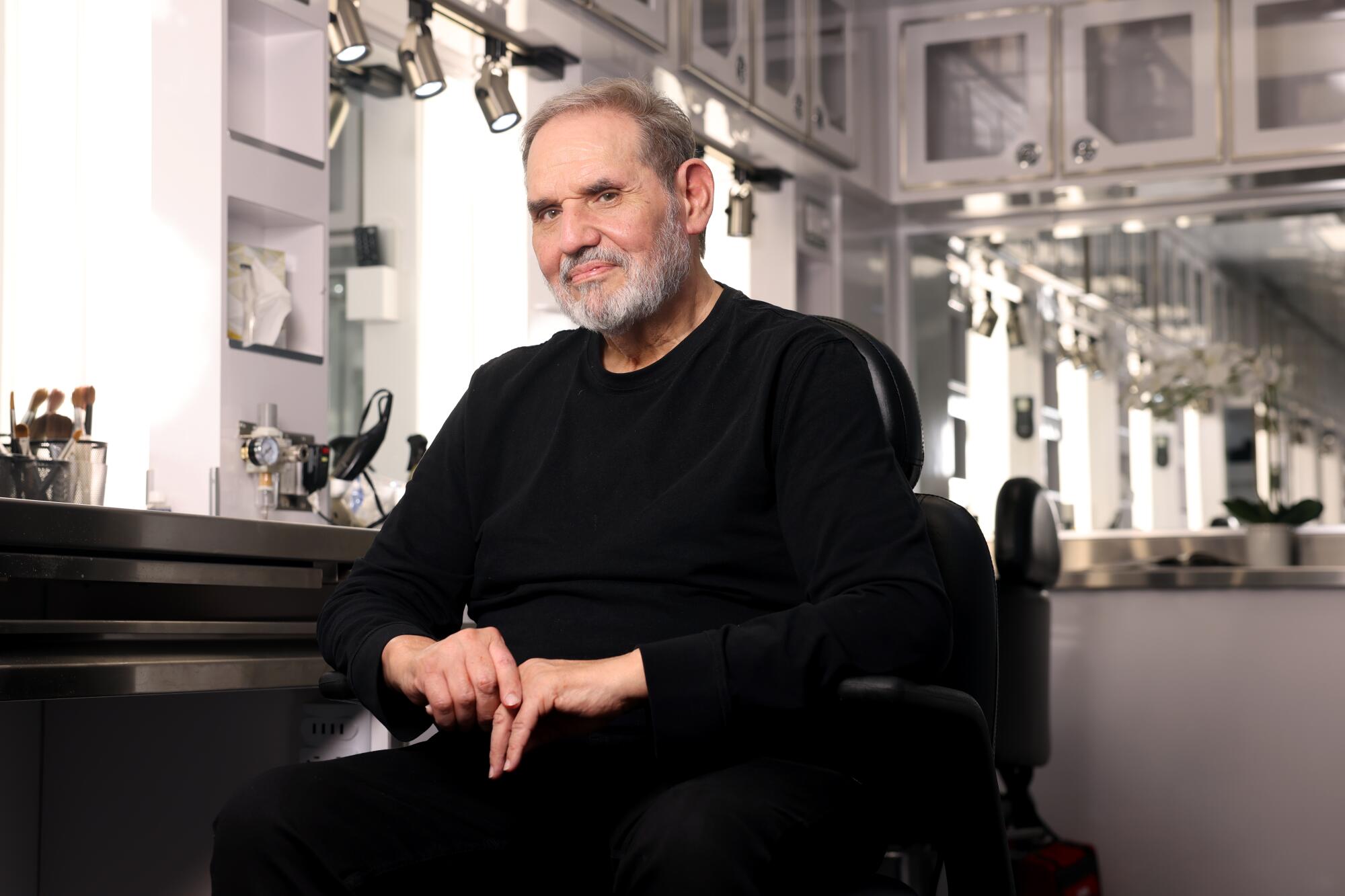 Man sitting in a makeup chair