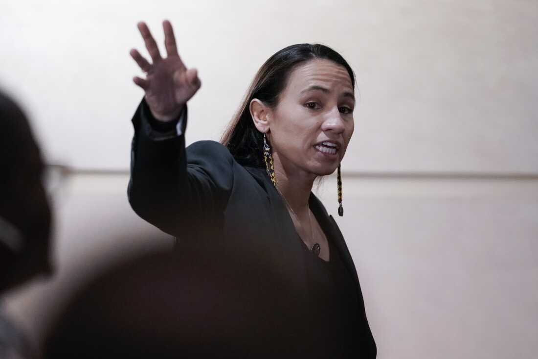 Rep. Sharice Davids, D-Kan., is shown in a midrange portrait, gesturing with one hand. She is a young woman of Native American descent.