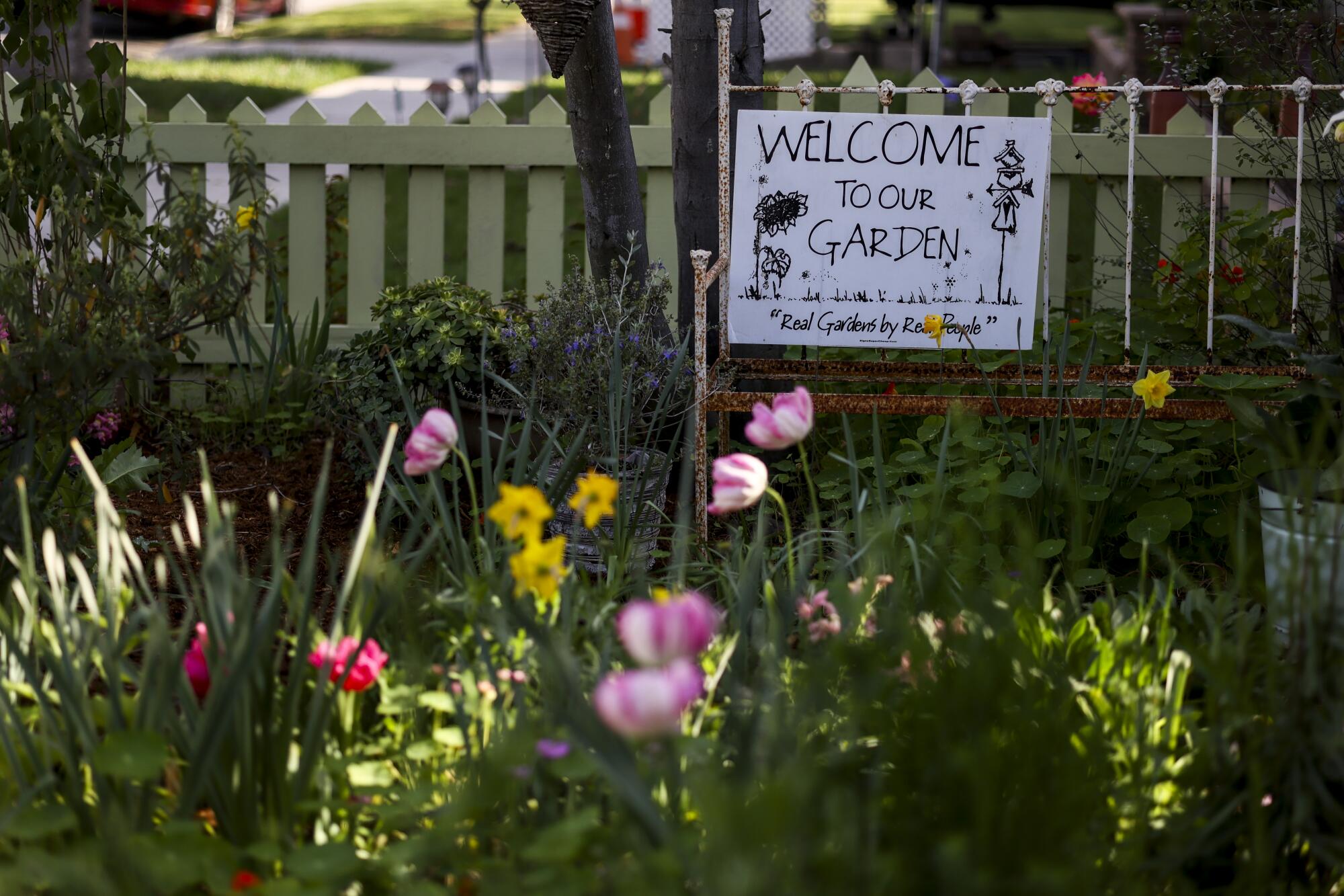 A welcome sign in a garden in Long Beach.