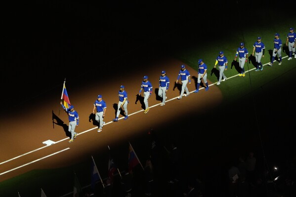 Venezuela enters the field at the start of the championship game of the World Baseball Classic against the United States, Tuesday, March 17, 2026, in Miami. (AP Photo/Lynne Sladky)