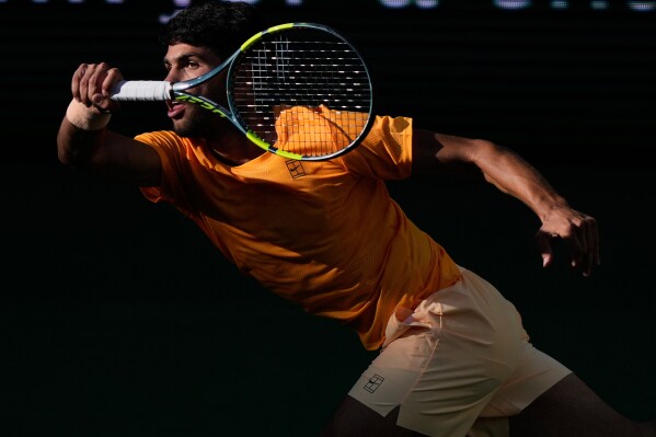 Carlos Alcaraz, of Spain, returns a shot against Daniil Medvedev, of Russia, during a semifinal match at the BNP Paribas Open tennis tournament, Saturday, March 14, 2026, in Indian Wells, Calif. (AP Photo/Mark J. Terrill)