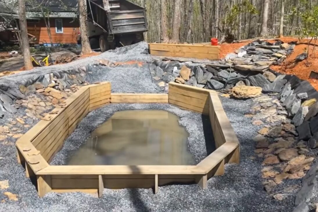 A natural pool with an excavation, waterfall, biological filter, and giant rocks shows how the island has become a bathing area.