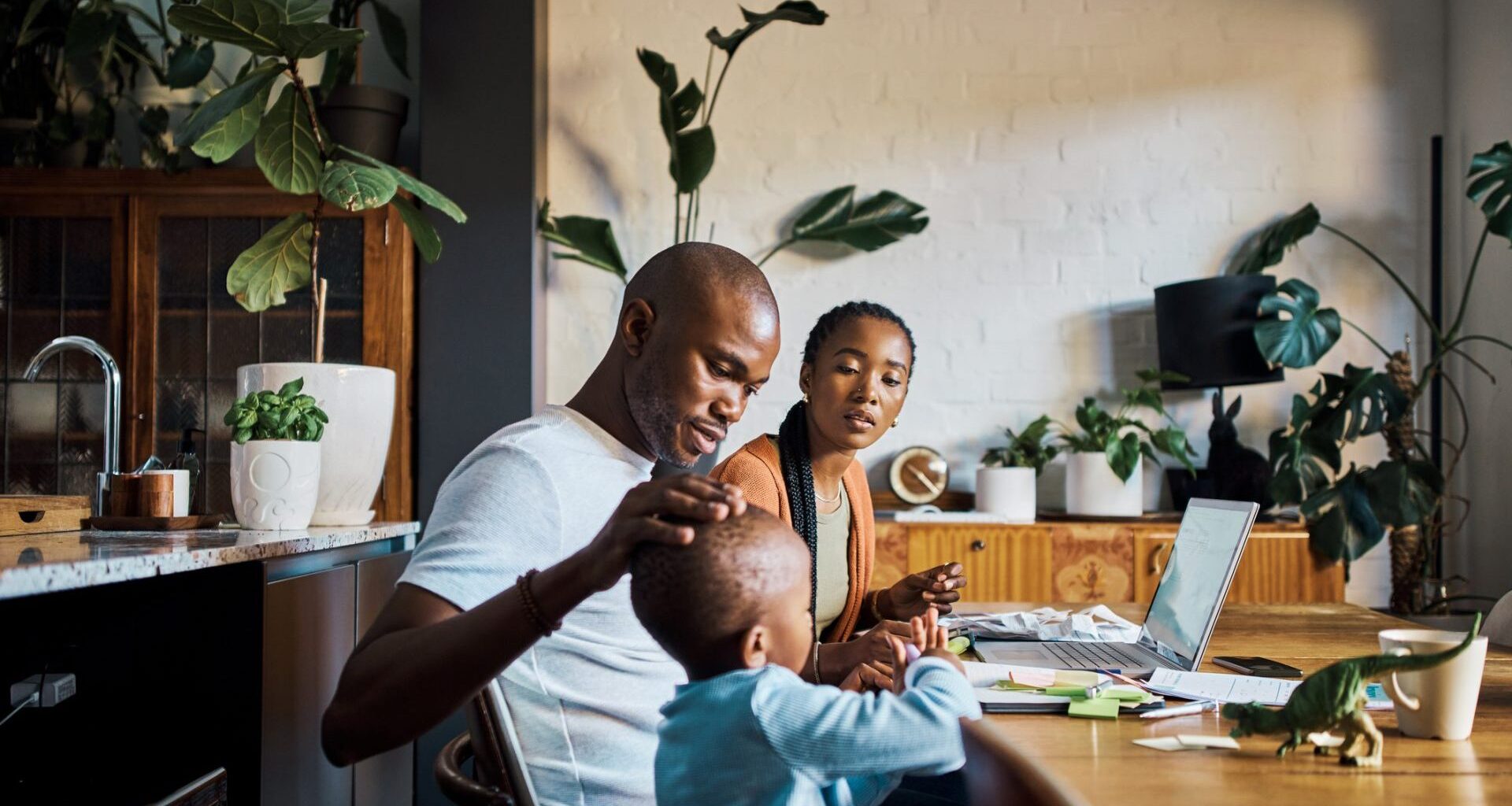 Family, children and budget with a couple using a laptop to invest or manage savings in the dining room of their home together.