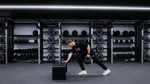 Marchon coach Patrick James demonstrating how to perform a single-arm row with a kettlebell