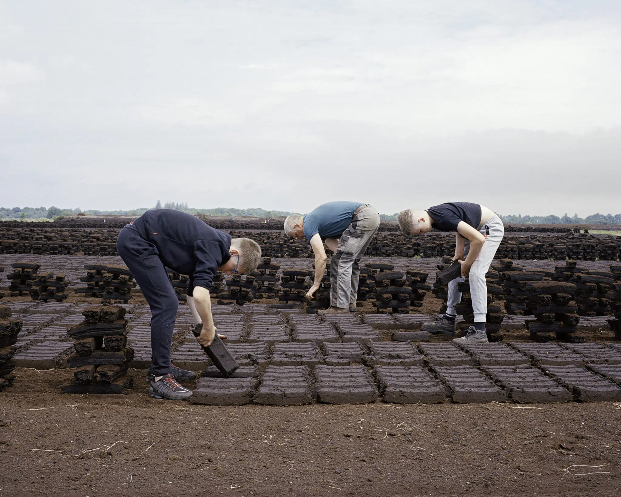 A family footing turf for domestic use in Ticknevin, County Kildare, Ireland.