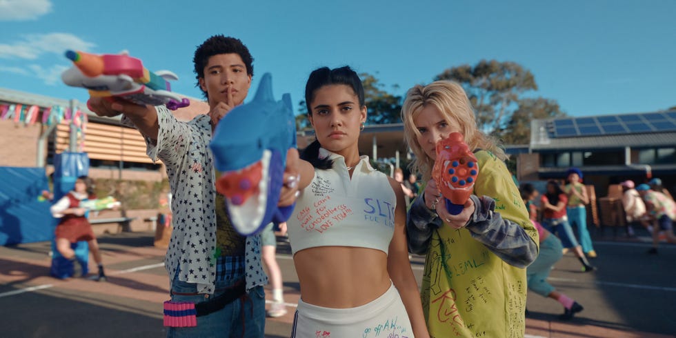 Heartbreak High season 3 Ayesha Madon, Asher Yasbincek and James Majoos as Amerie, Harper and Darren.jpg heartbreak high season 3 ayesha madon, asher yasbincek and james majoos as amerie, harper and darren holding water pistols at school