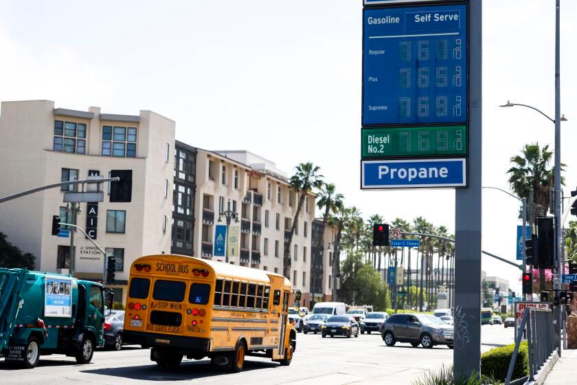 Los Angeles, CA - March 03: A school bus passes a Chevron gas station selling $7.61 regular gas along North Alameda Street on Tuesday, March 3, 2026 in Los Angeles, CA. The average price of a gallon of self-serve regular gasoline in Los Angeles County rose today to its highest amount since Nov. 29, increasing 2.4 cents to $4.724. (Kayla Bartkowski / Los Angeles Times)