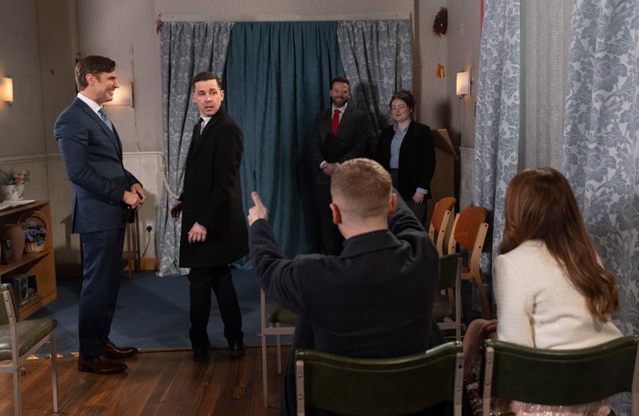 Gary and Maria point towards Todd and Theo in the registry office in a scene from Coronation Street