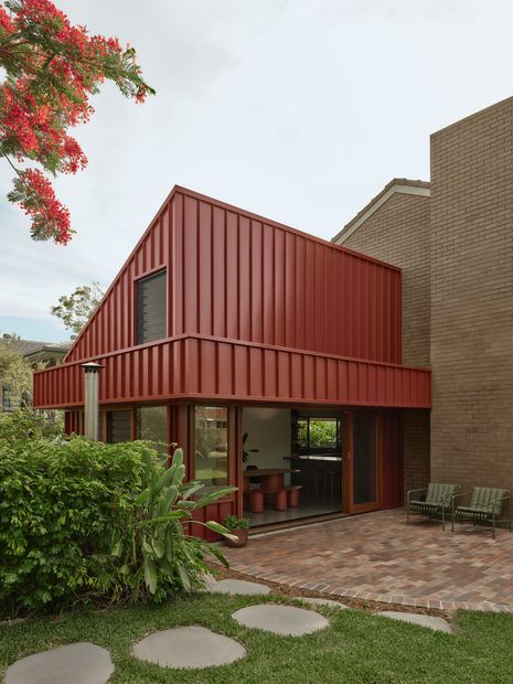 The metal-clad pavilion maintains a substantial, punchy profile in a visual language similar to the existing house.