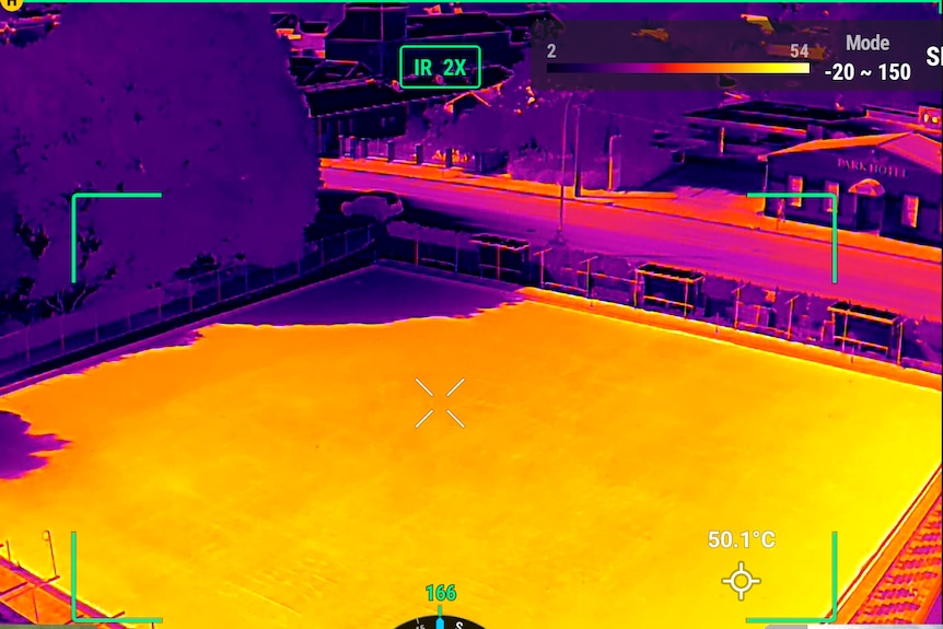 A colour-coded infared drone photo from an angle looking over a synthetic bowls green showing the difference in tempreature.