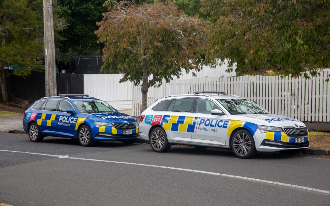 Police are present at a location in Mt Albert where a person is believed to have died in unknown circumstances. A body lays in the gutter on the other side of the black van.