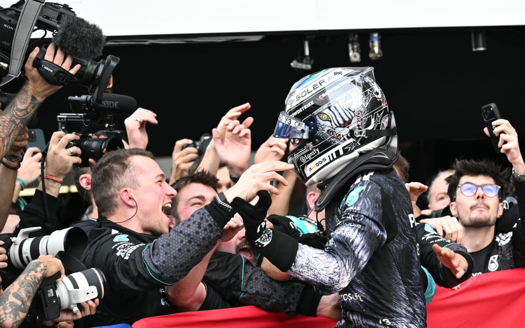Mercedes' Italian driver Kimi Antonelli celebrates with his team after winning the Formula One Japanese Grand Prix.