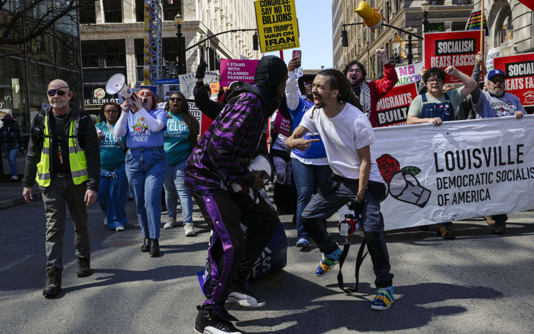 LOUISVILLE, KENTUCKY - MARCH 28: Protesters chant and march in the streets during a 