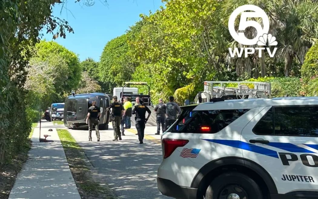 A photo from CNN affiliate WPTV shows a Range Rover on its side at the scene where authorities say Tiger Woods was involved in a rollover crash on Jupiter Island, Florida, on Friday, 27 March.