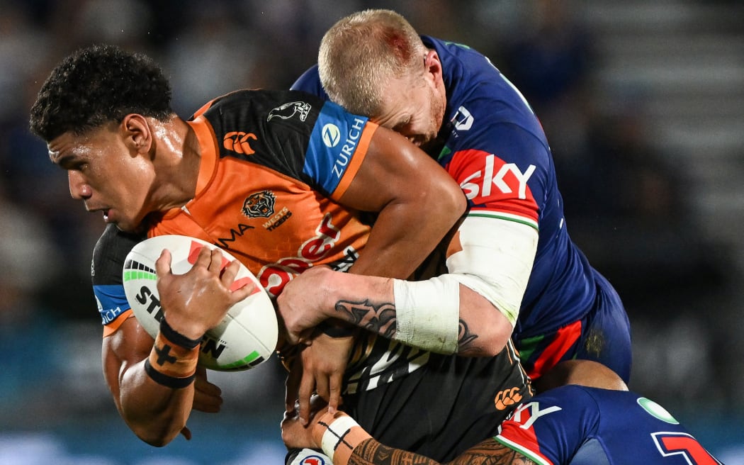 Luke Laulilii of Wests Tigers tackled by Mitchell Barnett of the Warriors, NZ Warriors v Wests Tigers, round 4 of the NRL Telstra Premiership rugby league match at Go Media Stadium, Auckland, New Zealand on Friday 27 March 2026. 
© Photo: Andrew Cornaga / Photosport