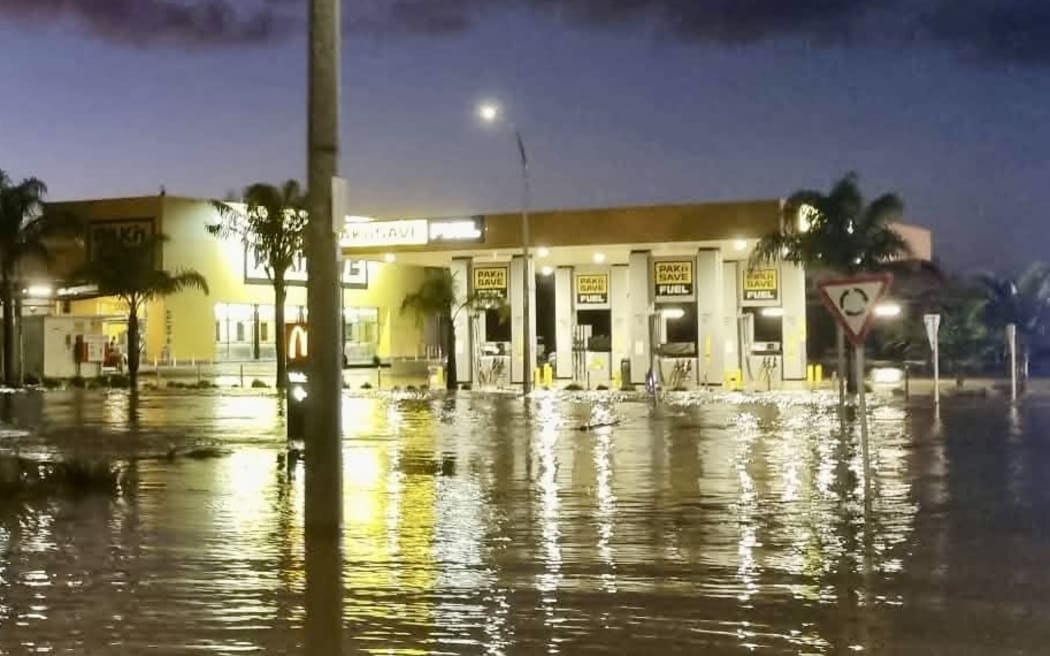 Toto Nicholson says the local Pak’nSave, McDonalds, car wash and Bells Produce store in Kaitaia are inundated with water from the Awanui River which runs behind the area.